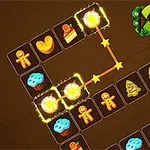 茶色の背景に、クッキーやカップケーキ、クリスマスツリーなどのアイコンが並ぶパズルゲームの画面。