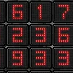 赤いドットで構成された数字が配置された黒い背景の四角いパネルの画像。