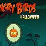 ハロウィンのテーマを持つ森の背景に、オレンジ色のカボチャの「PLAY」ボタンがあります。