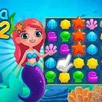 赤い髪の人魚が海底でパズルゲームの画面を指差しているイラスト。