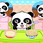 緑色のテーブルでフォークを持つパンダがスパゲッティを食べている様子。