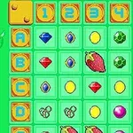 緑色のグリッドには、数字、宝石、果物、モンスターなどのカラフルなアイコンが並んでいる。