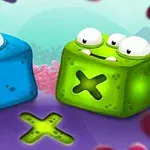 青と緑の立方体のキャラクターが目と口のある可愛いデザインで、中央に「X」の形がある。