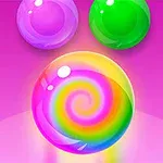 ピンクの背景に、中央に虹色の渦巻き模様のボールと、上部に紫と緑の2つのボールが描かれている。