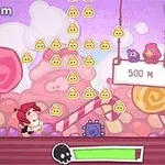 赤い帽子をかぶったキャラクターが砂糖菓子でできた背景の中で、スリングショットのような装置から飛ばされる様子。