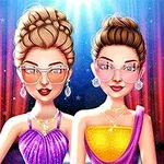 舞台の前でサングラスをかけた2人の女性が華やかなドレスを着て立っている。