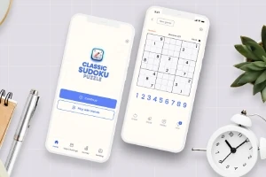 2台のスマートフォンが卓上に置かれており、1台には数独のロゴが表示され、もう1台には数独のパズルが表示されている。