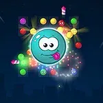 青い背景に、大きな青い球体のキャラクターが真ん中にあり、周囲にカラフルな弾やキャンディなどが浮かんでいる。