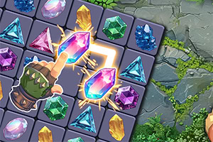 カラフルな宝石が並ぶパズルゲームのボードに、革の手袋をはめた指が発光するピンク色の宝石を指している。