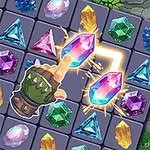 カラフルな宝石が並ぶパズルゲームのボードに、革の手袋をはめた指が発光するピンク色の宝石を指している。