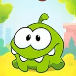 緑色のキャラクターが森の中に座っている。