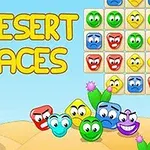 砂漠の背景にカラフルな顔のブロックと「DESERT FACES」という文字があります。