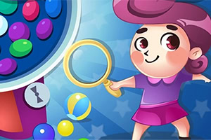 紫色の服を着たキャラクターが虫眼鏡を持って、カラフルなボールが入ったガチャガチャと並んで立っている。