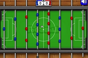 緑色のフィールドに赤と青の選手が配置されたテーブルサッカーゲームの画像。