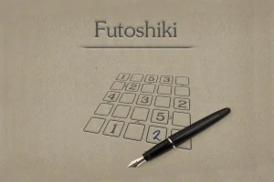 ペンが置かれた数字パズルのグリッドが描かれている画像。