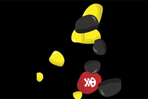 黒い背景に黄色と黒の石が積み重なり、その中に赤い石に「XO」と書かれたものがある画像。