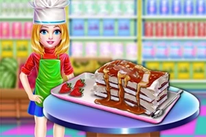 女性シェフがイチゴを添えたキャラメルソースのかかったケーキを見せている。