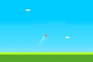 青空の下、緑の地面の上をサッカーボールが飛んでいる風景。