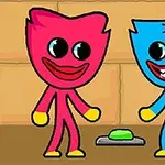 赤いキャラクターと青いキャラクターが緑のボタンの前に立っているイラスト。