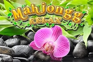 ピンクのランの花が黒い石と緑の葉の上に置かれている画像。