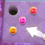 紫色の背景に、三つの色の異なる宝石と矢印、穴があるイメージ。