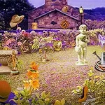 庭園の中心に彫像があり、周囲にさまざまなオブジェクトや花々が配置されている風景。