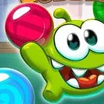 緑色のキャラクターがカラフルな泡に囲まれて笑顔でいる。