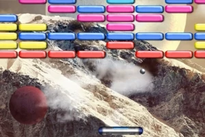 色とりどりのレンガが並んだ背景に、山と球体が浮かぶ画像。