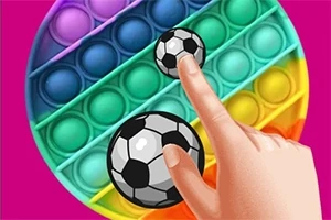 カラフルなラウンド型のポップイットの上に置かれたサッカーボールで、手がそれに触れている。