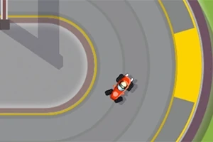 赤いレーシングカーが曲がりくねった灰色のトラックを走行している上からの視点。