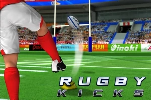ラグビー場で赤いユニフォームの選手がボールをキックしている様子。