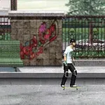 舗装された道に立つスケートボーダーと、後ろにレンガの壁とグラフィティ。