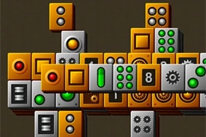 色とりどりのボタンやギアの模様があるオレンジとグレーのブロックが積み重なっている画像。