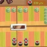 色とりどりの寿司が並べられた木製ボードと得点が表示されている画面。