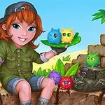 緑のシャツを着た少女が、カラフルなふわふわの生き物を手に乗せて座っている。