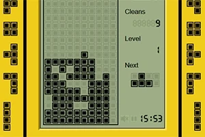 黄色の枠に囲まれた画面で、黒い四角いブロックが積み上がっており、次のブロックの形が右に表示されている。