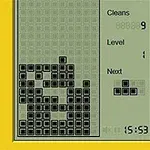 黄色の枠に囲まれた画面で、黒い四角いブロックが積み上がっており、次のブロックの形が右に表示されている。