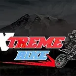 バイクに乗るライダーのシルエットと「XTREME BIKE」という文字、背景に山。