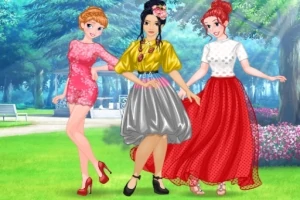 公園の背景でカラフルなドレスを着た3人の女性がポーズをとっている。