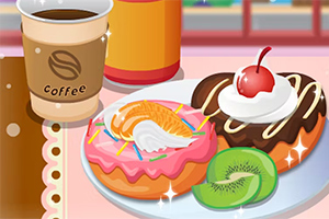 カフェのテーブルに置かれたドーナツとフルーツ、コーヒーカップ。