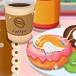 カフェのテーブルに置かれたドーナツとフルーツ、コーヒーカップ。